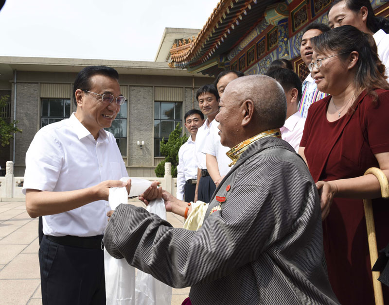 来自西藏自治区的65岁藏族乡村教师琼色向李克强献上哈达.jpg